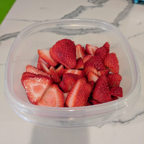 add strawberries to tupperware